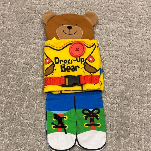 Melissa & Doug Soft Activity Baby Book - Dress Up Bear - Picture 1 of 3